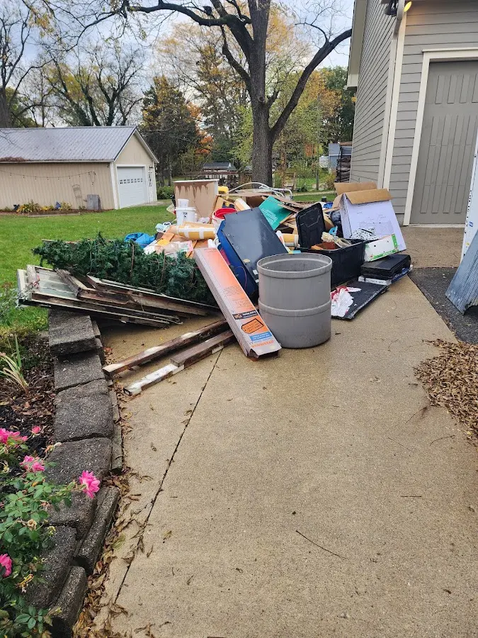 Dumpster being loaded with debris for Roofing Dumpster Rental in Moorhead